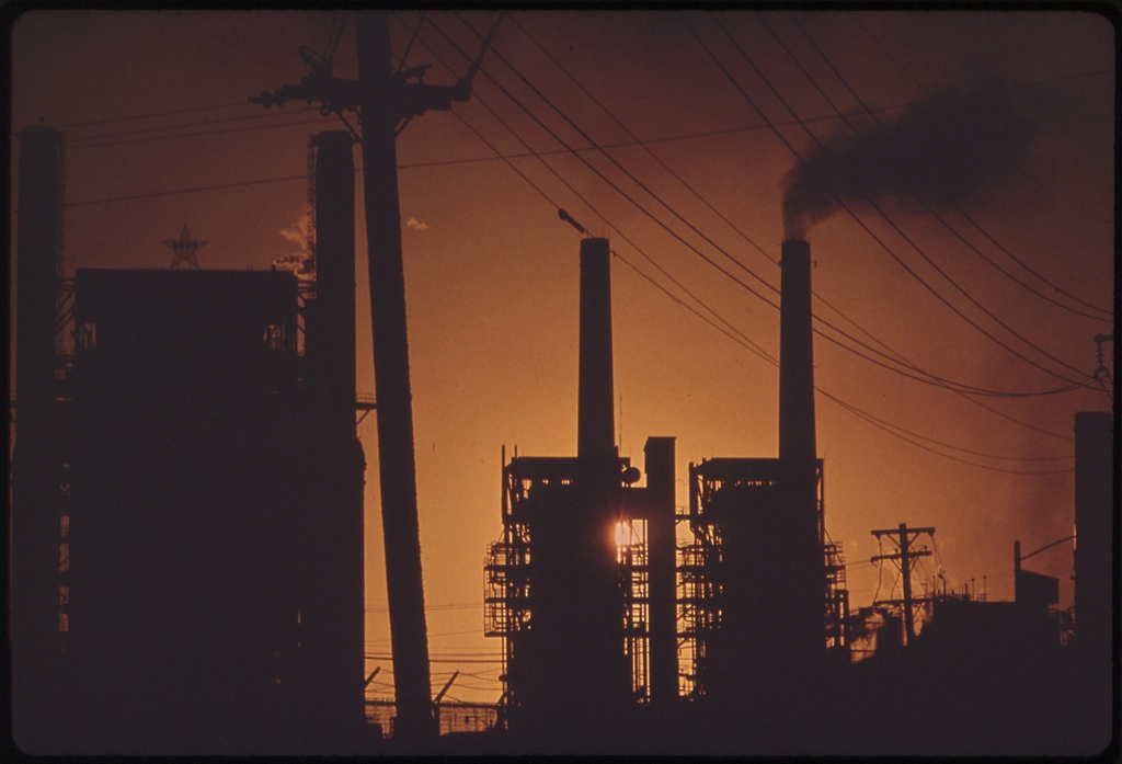 Oil refinery at dusk as crude prices climb