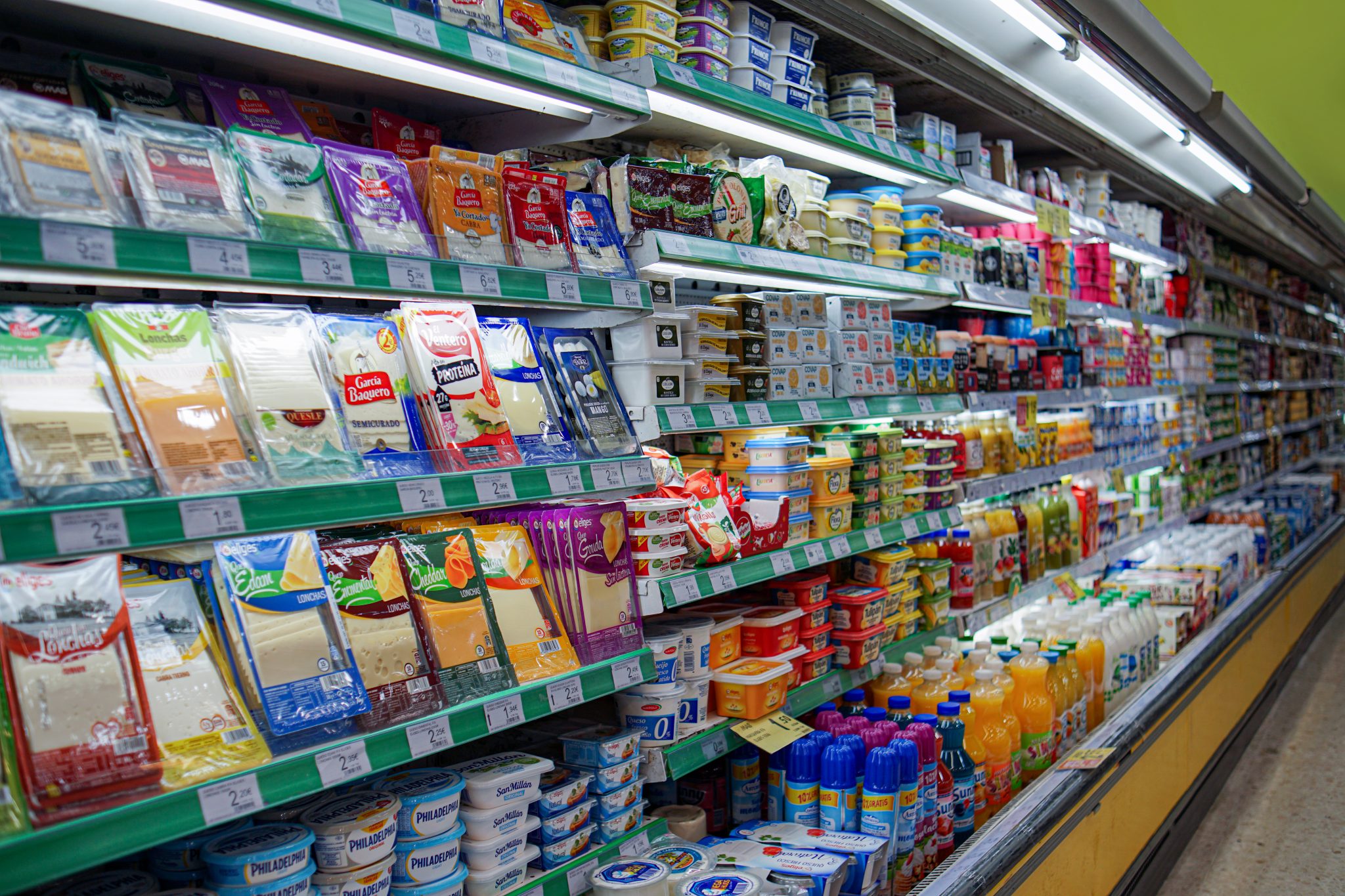 Rows of grocery shelves in a supermarket aisle